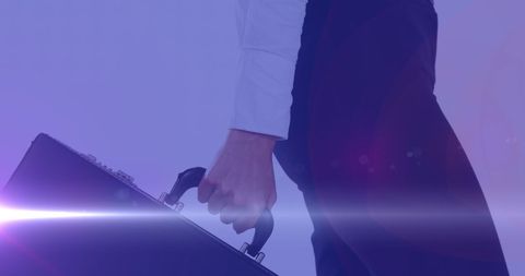 Businesswoman Walking with Briefcase Illuminated by Colored Lights