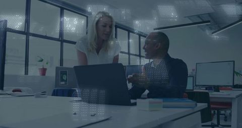 Colleagues Collaborating over Laptop in Minimalist Office with Futuristic Data Overlay