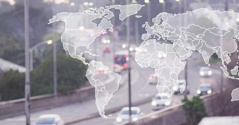 Translucent world map overlaying urban highway at dusk showing cars moving in traffic