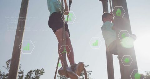Boys Climbing Ropes at Park with Digital Data Overlay