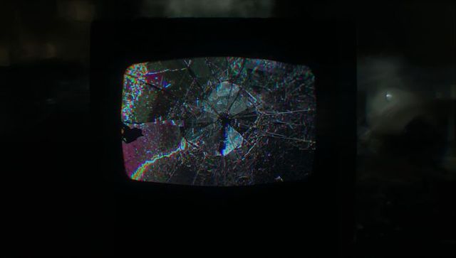 Abandoned CRT TV with Glitch Patterns in Dim Basement