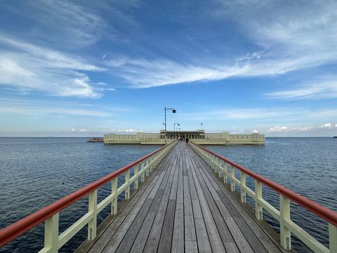 Serene Pier Leading to Idyllic Seaside Building