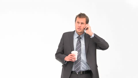 Confident Businessman Holding Coffee While on Phone