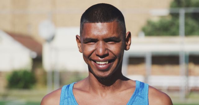 Young Smiling Man in Blue Tank Top Outdoors - Download Free Stock Images Pikwizard.com