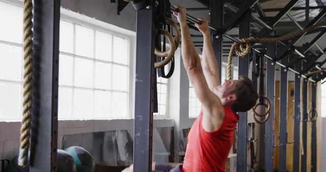 Man Exercising with Gymnastic Rings in Modern Gym - Download Free Stock Images Pikwizard.com