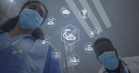 Medical team leaning over monitor showing telemedicine cloud and data analytics holograms