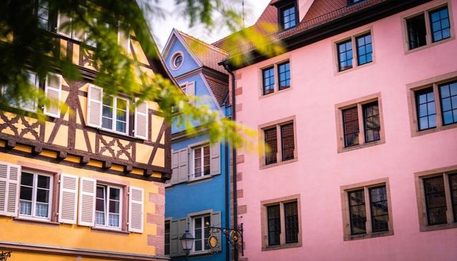 Colorful european old town facades featuring yellow half-timbered house and pastel buildings