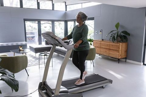 Senior African American Woman Walking on Treadmill at Home