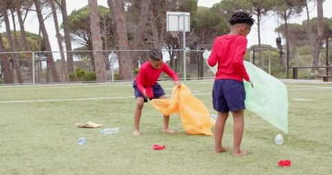 Diverse Children Enjoying Outdoor Play with Colorful Fabrics