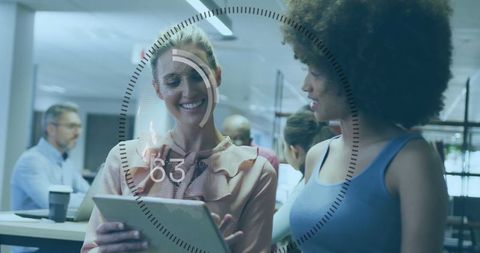 Businesswomen Collaborating with Digital Insights Overlay