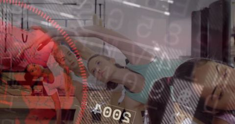 Group pilates stretching class with focused woman reaching and red digital gauge overlay