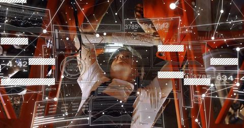 Mechanic lying beneath red chassis using augmented reality diagnostic overlay