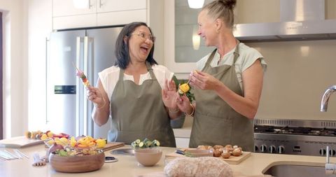 Diverse Senior Women Enjoy Cooking Together in Modern Kitchen