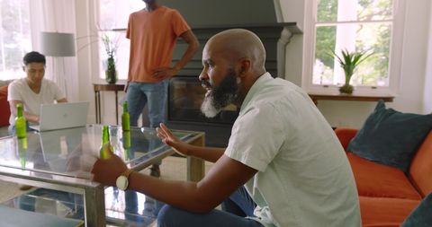 Friends Enjoying Drinks and Conversation in Cozy Living Room