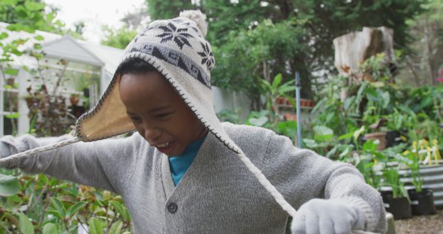 Child in Warm Hat Exploring Backyard Garden in Winter - Download Free Stock Images Pikwizard.com