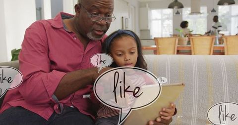 Grandfather and Granddaughter Connecting Through Digital Technology