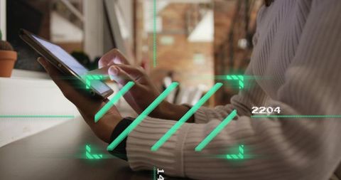 Woman tapping tablet with ar hud overlay at coworking cafe counter, modern workspace