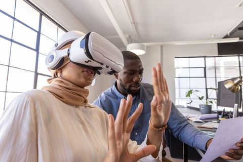 Diverse Coworkers Leveraging VR Technology in Modern Office