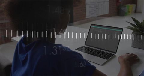 Businesswoman analyzing waveform data on laptop at modern workspace