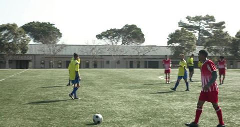 Soccer Players Strategizing on Field for Upcoming Match
