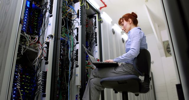 Female IT Professional Working in Server Room with Laptop - Download Free Stock Images Pikwizard.com