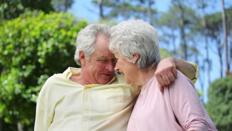 Elderly Couple Sharing a Joyful Moment in Relaxing Park