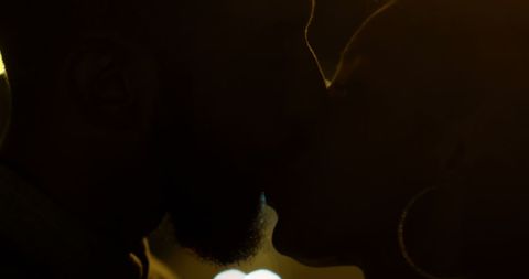 Silhouette of Romantic Couple Kissing at Night