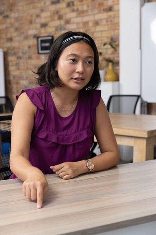 Focused Businesswoman Pointing During Corporate Discussion