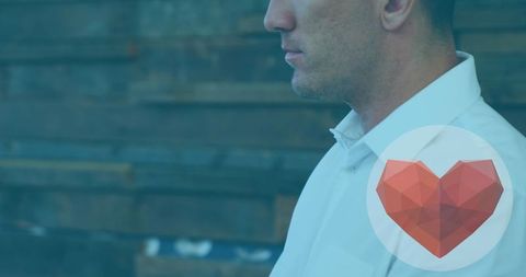 Focused Businessman Laptops with Digital Heart Icon Overlay