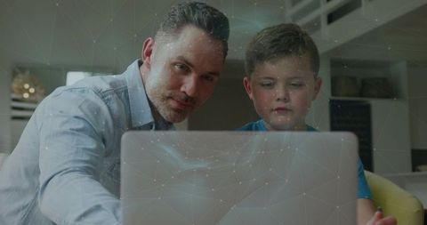Father Teaching Son on Laptop at Home Learning Together Remote Study Family Bonding
