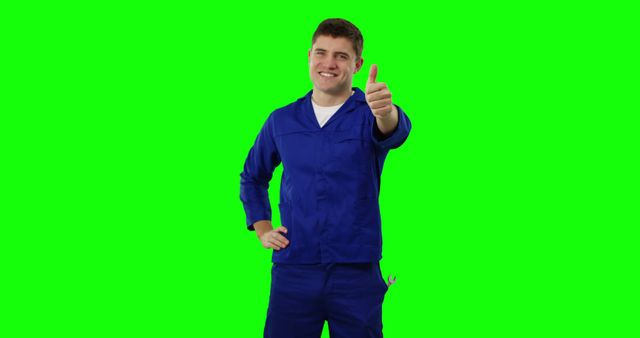 Smiling Male Worker in Blue Coveralls Giving Thumbs Up on Green Screen - Download Free Stock Images Pikwizard.com