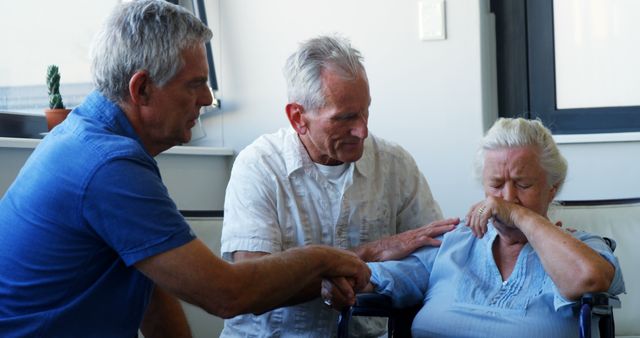 Senior Woman in Emotional Moment Comforted by Two Elderly Men Indoor - Download Free Stock Images Pikwizard.com