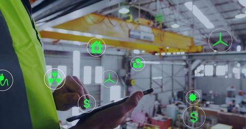Technician inspecting industrial plant with tablet and ar energy icons overlay, yellow crane
