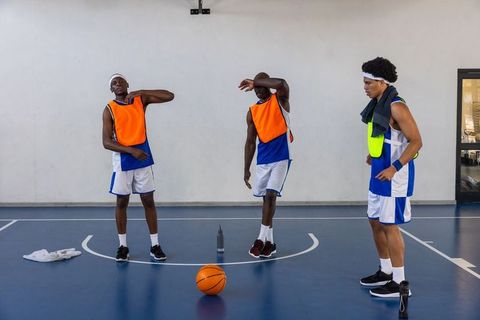 African American Basketball Players Practicing Drills in Gym