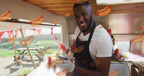 Happy Man Preparing Hot Dogs in Outdoor Food Truck