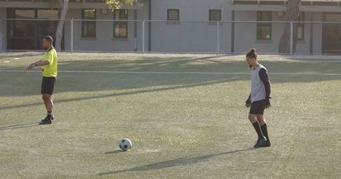 Female Soccer Player Practicing on Sunny Field