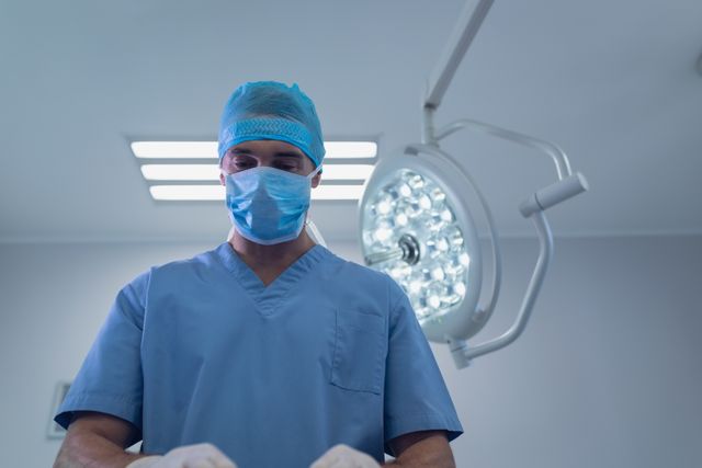 Male Surgeon performing operation in operation theater at hospital