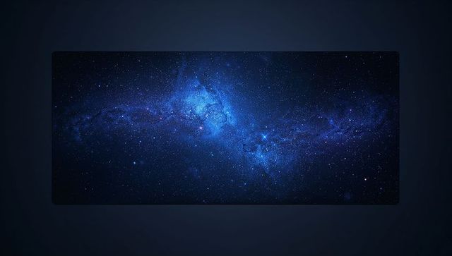 Illuminated wide screen display showing deep blue nebula starfield with soft bezel glow