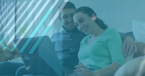 Couple Using Laptop with Global Technology Overlay at Home