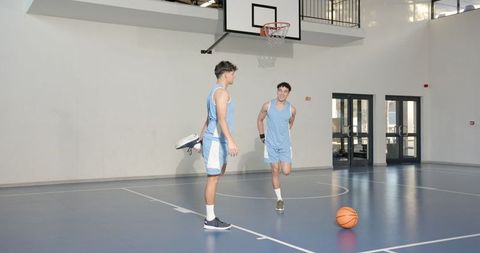 Male Basketball Players Stretching in Indoor Court