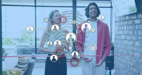 Young professionals cutting ribbon, networking in office with social media network overlay