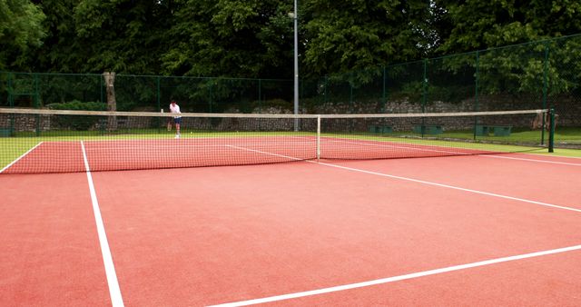 Person on Outdoor Tennis Court Preparing to Serve - Download Free Stock Images Pikwizard.com