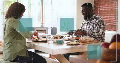 Couple Sharing Homecooked Roast Chicken Dinner at Sunlit Rustic Dining Table