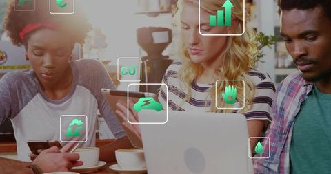 Young professionals collaborating on devices in cafe with eco fintech augmented icons