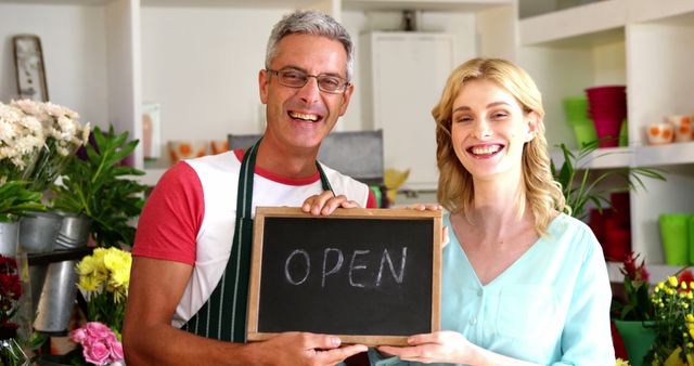 Flower Shop Owners Holding Open Sign and Smiling in Store - Download Free Stock Images Pikwizard.com