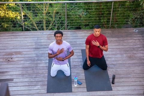 Men practicing mindfulness meditation wellness outdoors