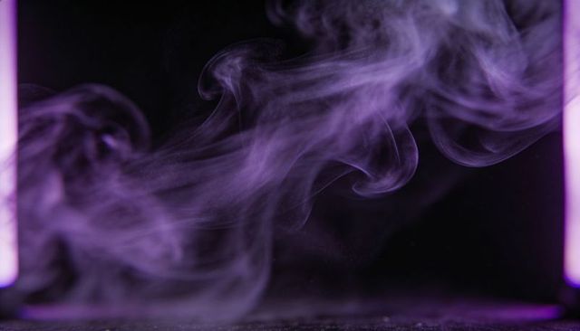 Violet smoke plume flowing over reflective black surface with neon side lighting