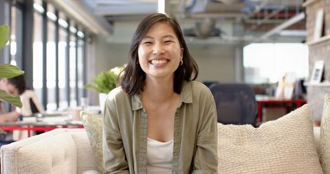 Smiling Young Woman in Modern Office Environment
