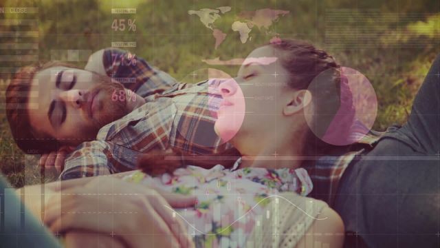 Young couple lying on grass during a picnic with digital overlay of financial charts and global data. Ideal for illustrating tech-driven lifestyle concepts, modern financial analysis presentations, or advertising intertwining nature and technology influence.