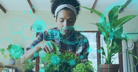 Woman Gardening Indoors with Futuristic Augmented Reality Interface
